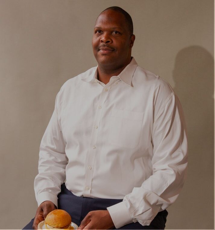 Big and tall man using a suit posing for the photo